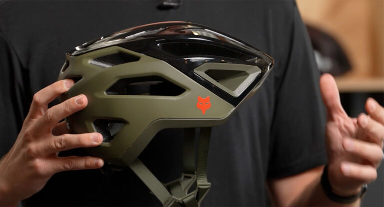 Man holding a Crossframe Pro helmet