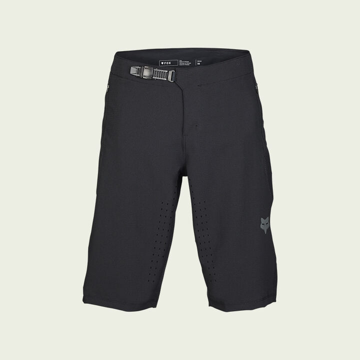 dark mtb shorts on green background